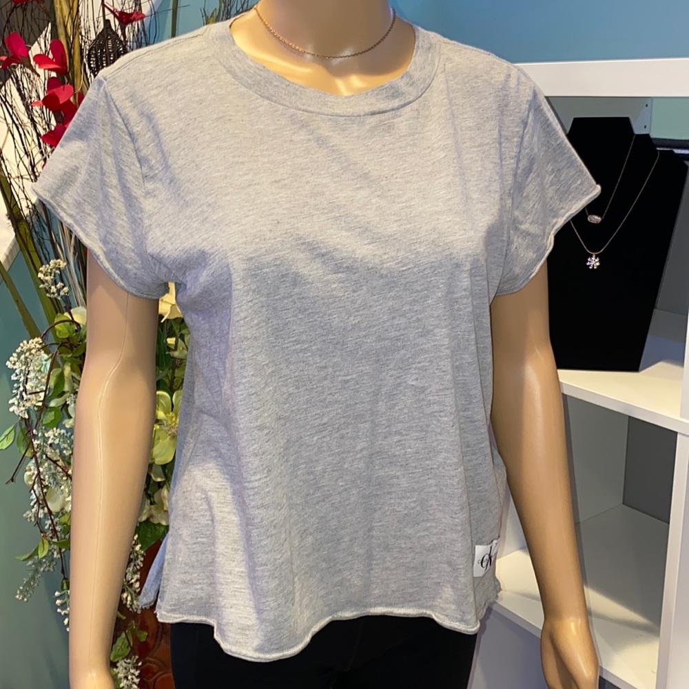 Like new! Gray Calvein Klein T-Shirt with logo patch. Rolled openings.
